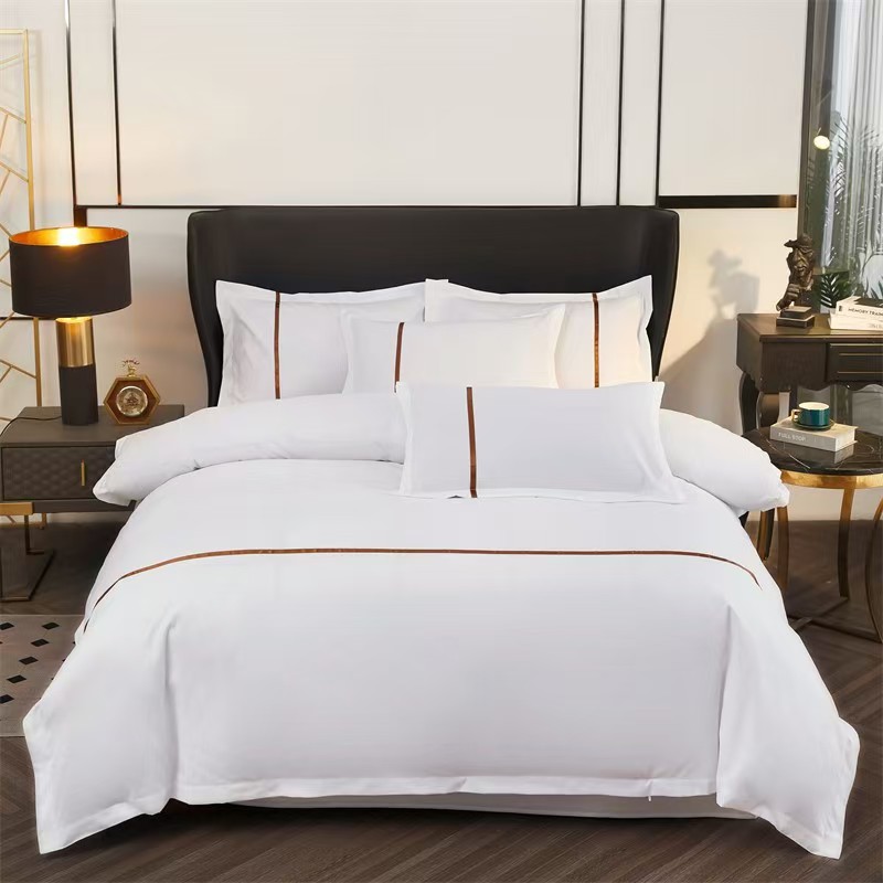 Hotel bed with white linen, pillows and duvet